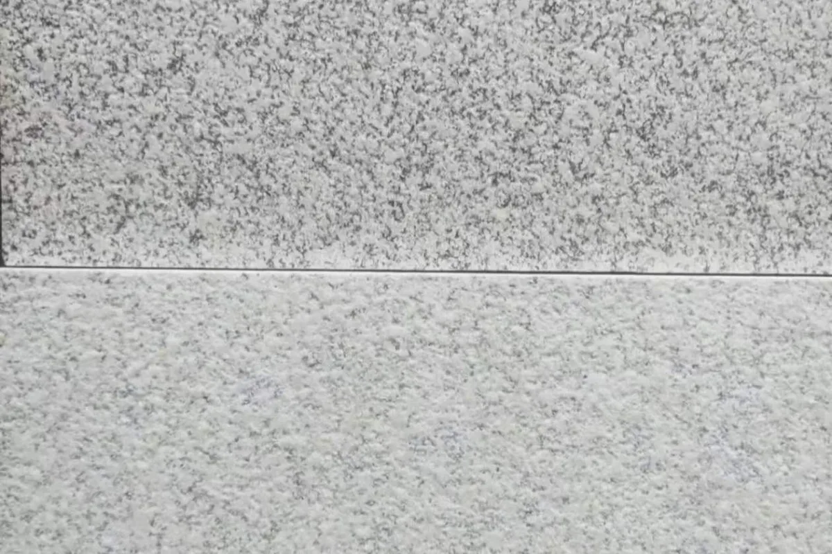 Close-up of two fired stone-pattern panel finishes and the joint between them